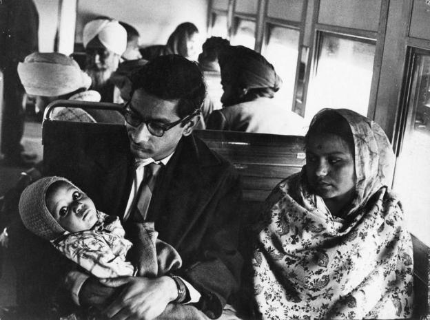 Museum number PHY.07736 T. S. Satyan, Young couple and baby on a train journey, 1970, H. 26.6 cm, W. 35.3 cm, Silver gelatin print